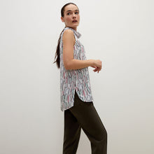 Side image of a woman standing wearing the Lise top in multicolor