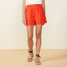 Front view of model wearing the poplin shorts in samba.