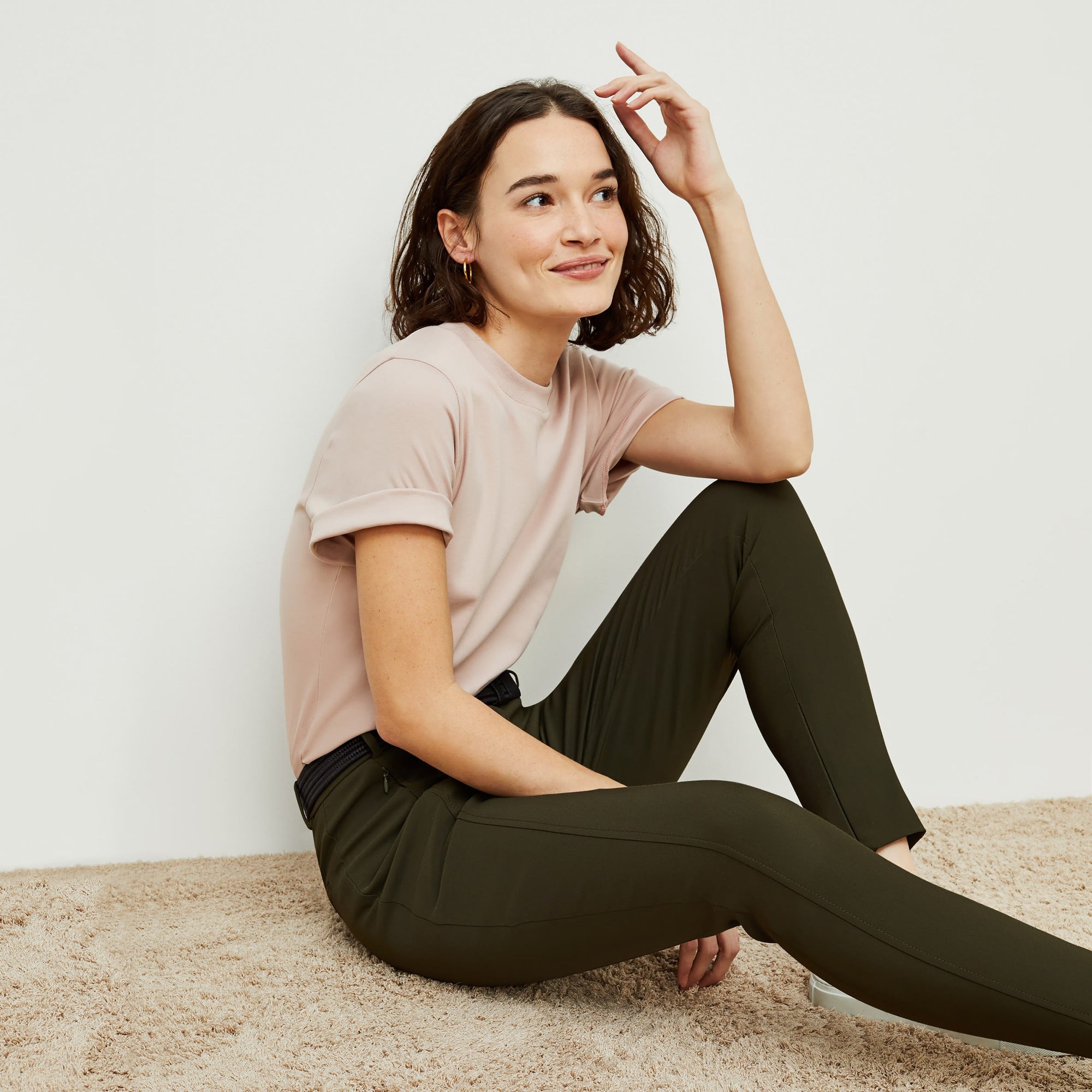 Side image of a woman standing wearing the curie pant in dark olive | Exclude