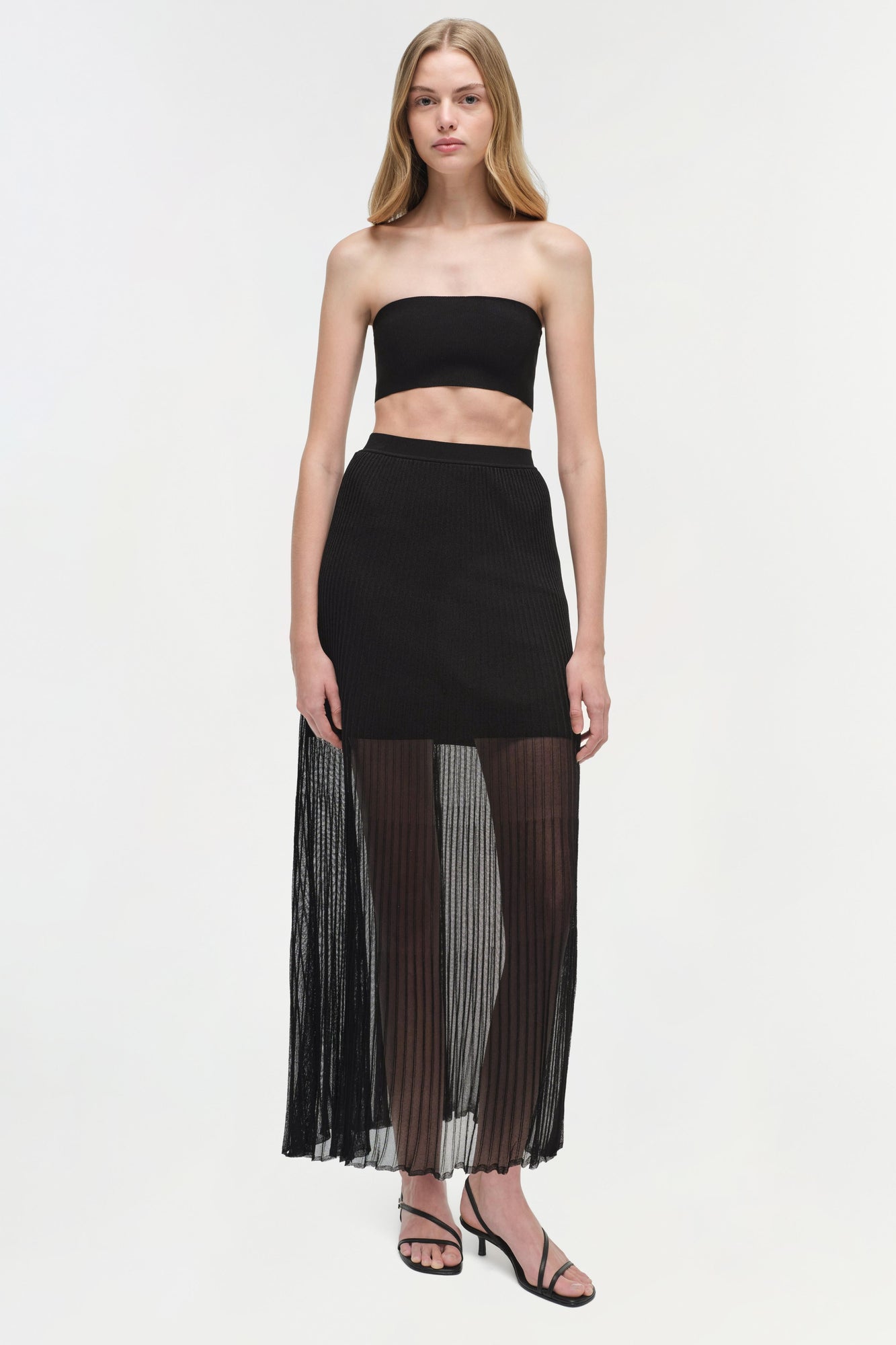 Black knit bralette with strapless bandeau neckline and crop silhouette.