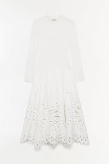 White knit midi dress with long sleeves and cutout embroidered detailing on the skirt.