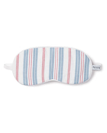 The Kids Sleep Mask in Vintage French Stripes by Petite Plume features blue and red vertical stripes on white, offering a timeless charm with its elastic strap and a PETITE tag.