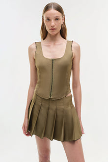 Olive green pleated mini skort with matching sleeveless vest top featuring center zip closure.