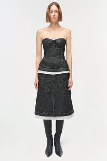 Black jacquard midi skirt with white waistband trim, worn with matching corset top and black boots.