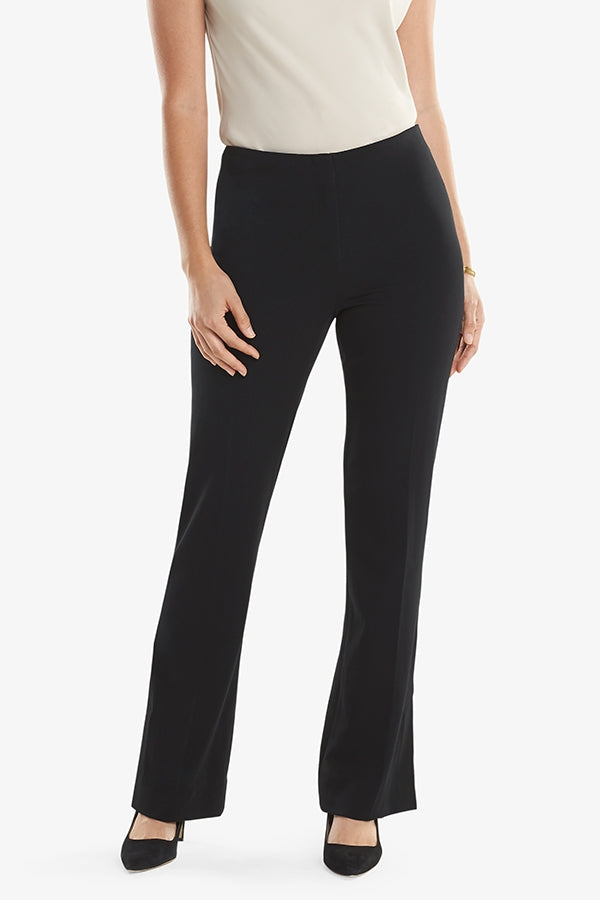 Front grid image of a woman standing wearing the Clooney pant in light twill in black. | Grid | Exclude