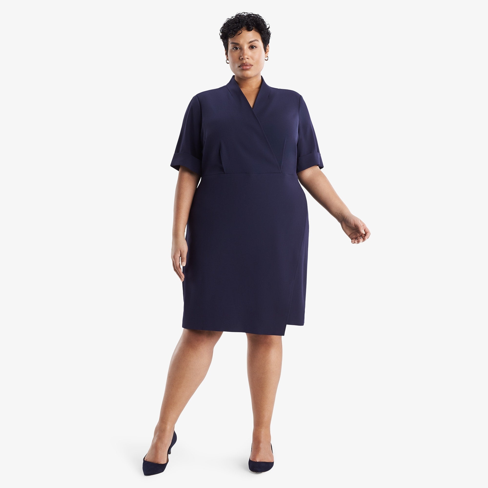 Front image of a woman standing wearing theTory Dress in dark iris