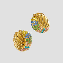 Gold hoop earrings with colorful gemstones on a white background