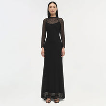 Black long-sleeved lace gown with sheer lace yoke and cuffs, floor-length silhouette.