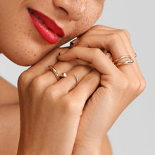 14k gold Quill Bypass Ring with diamond. Styled on a hand with multiple quill bypass rings.