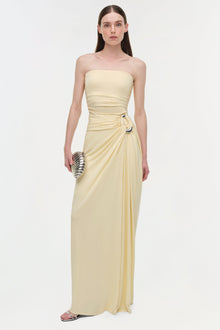 Cream strapless draped gown with ruched waist detail and side buckle accent.