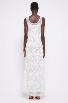 White sleeveless maxi dress with textured fringe detailing throughout, shown from back view on model.