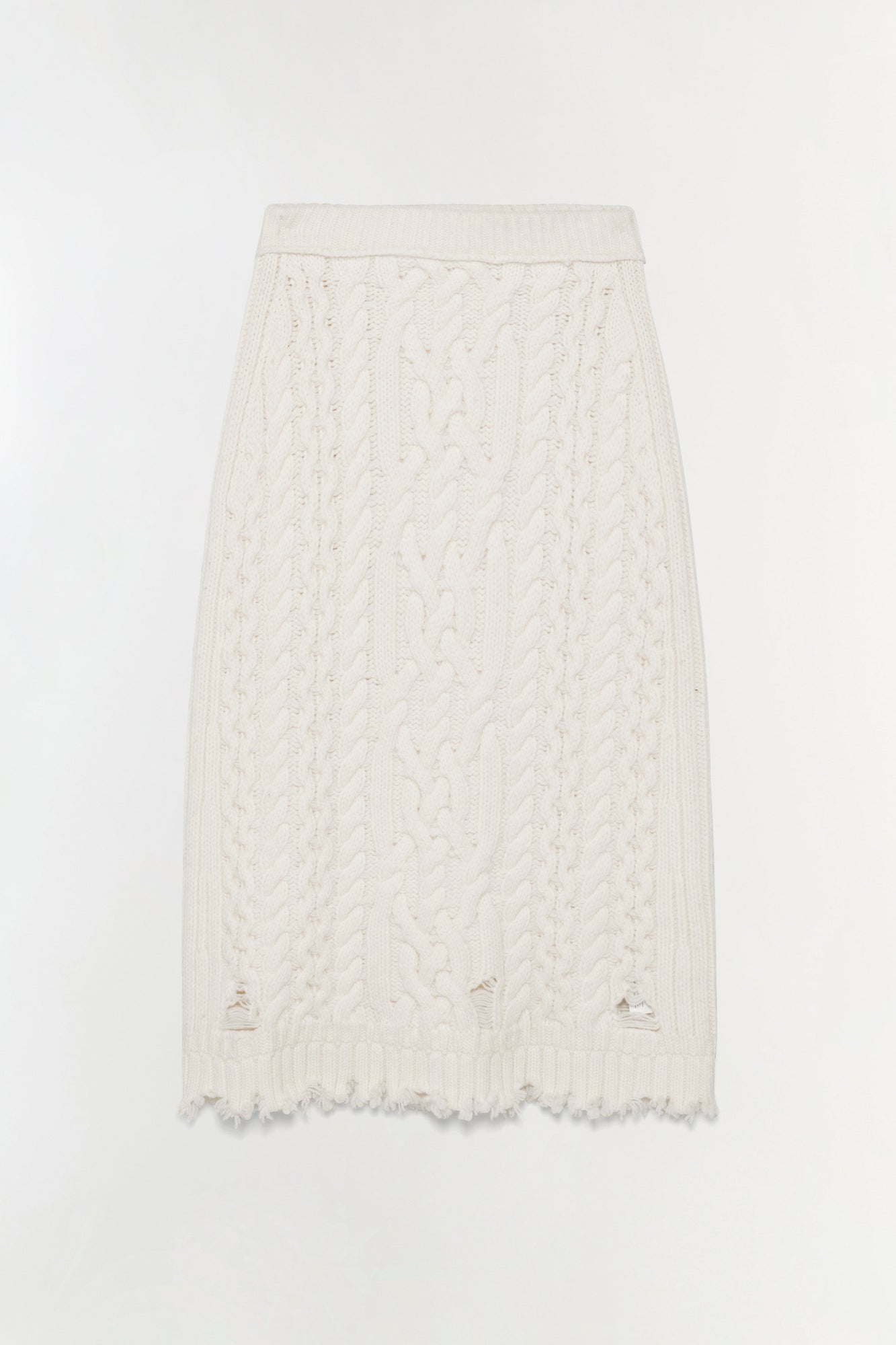 Cream cable-knit midi skirt with distressed hem and cutout details at the thighs.