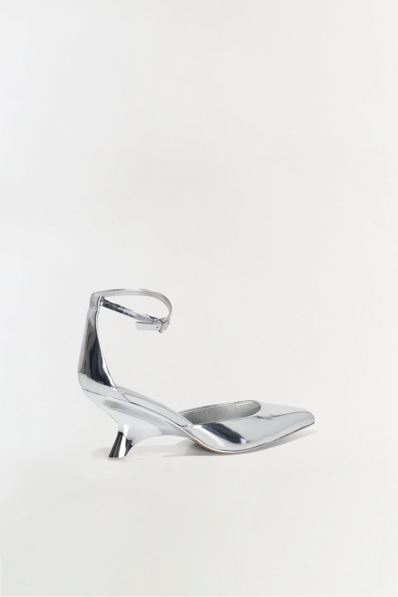 Silver metallic leather wedge heel with pointed toe and ankle strap buckle closure.
