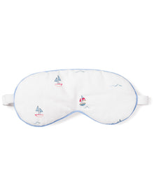 The Adults Twill Sleep Mask in Bateau by Petite Plume is a white mask with light blue trim and colorful sailboat designs. It has an adjustable strap for a luxurious sleep experience and makes a perfect monogrammed gift for those who appreciate elegance at bedtime.