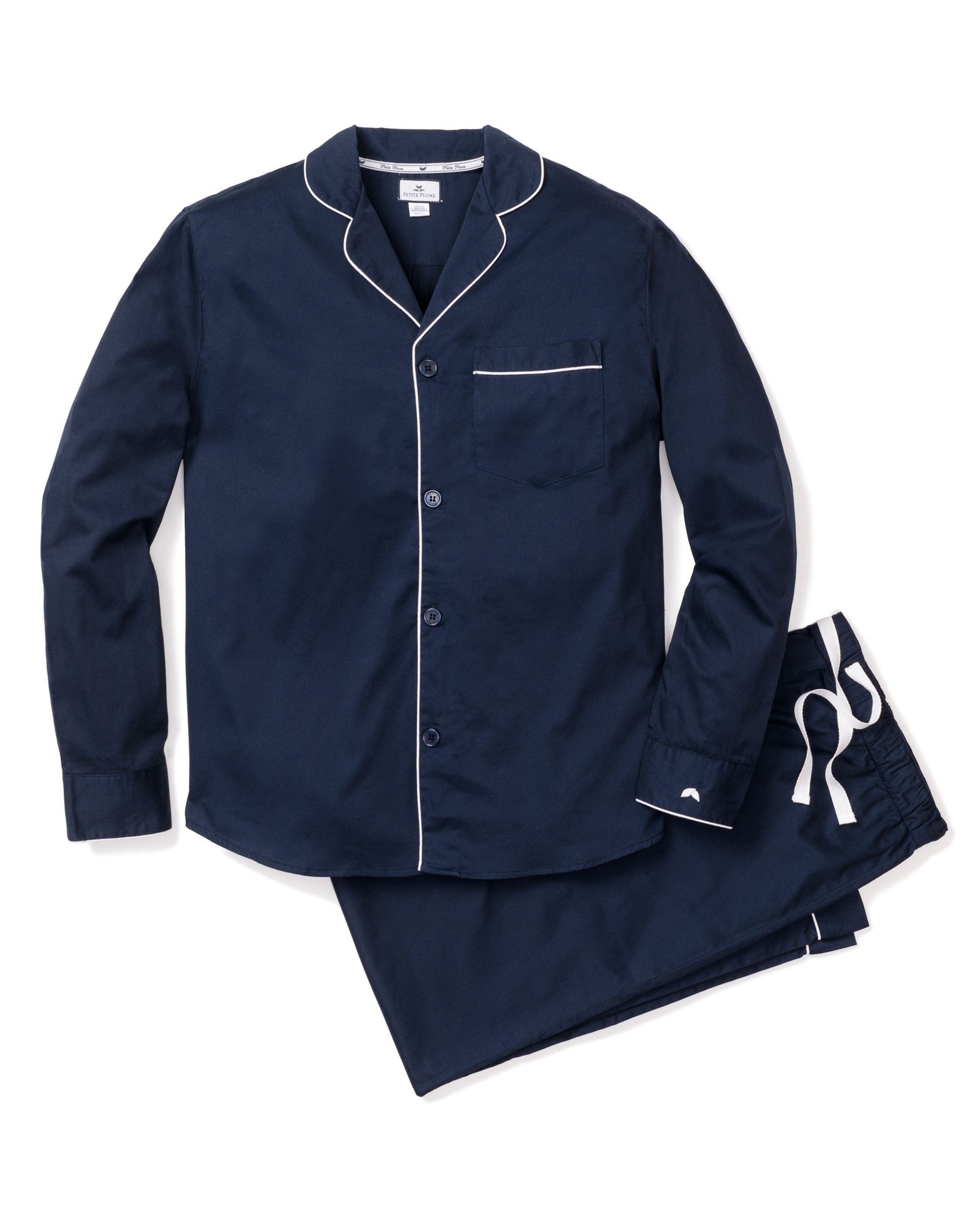 The Petite Plume Mens Twill Pajamas in Navy, featuring elegant white piping, include a long-sleeved button-up top with a chest pocket and matching drawstring pants—perfect for stylish sleepwear.
