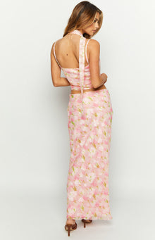Rear-side view of a pink floral print maxi skirt with a relaxed fit and flowy drape