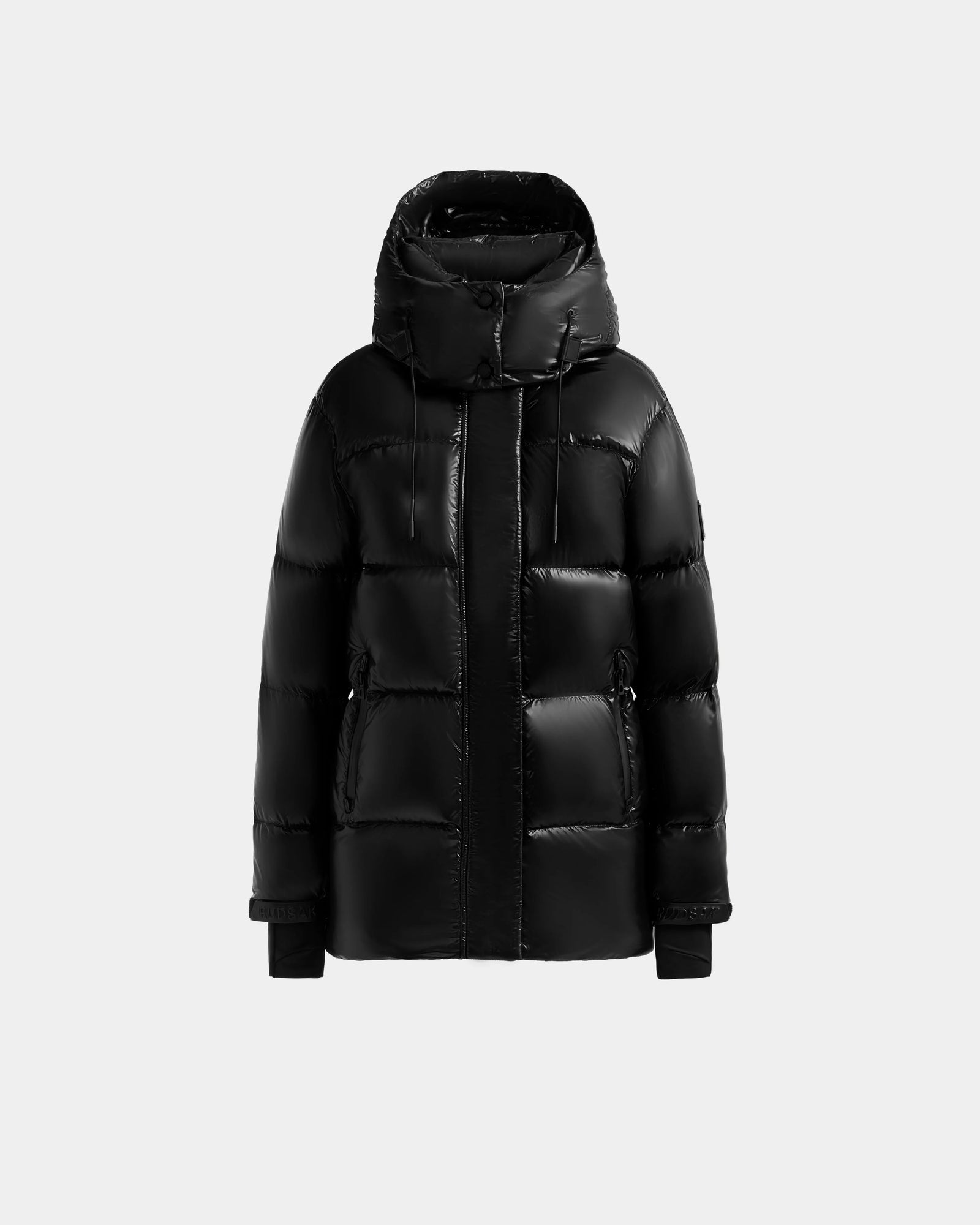 The Rudsak ALESSANDRA S-S - L125560 Black is a glossy women's down puffer jacket with a hood, front zipper, and two side pockets, shown against a plain light gray background.