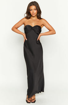 Front view of a black strapless maxi dress with a twisted ruched bust detail and a flowing skirt