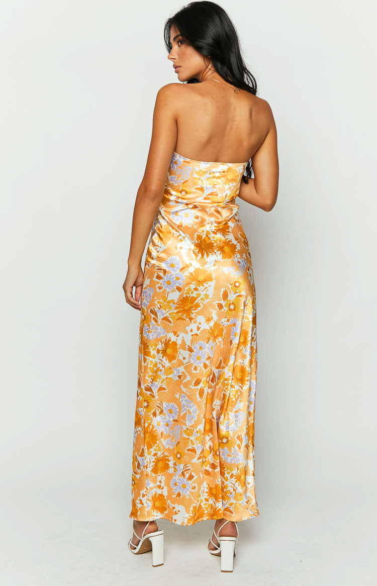 Rear view of an orange floral satin strapless maxi dress with a straight back and subtle sheen