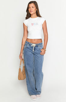 Mid wash denim jeans with a cream tie waist and a relaxed wide-leg fit