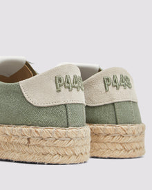 Back view of P448 green canvas low-top sneaker with tan recycled suede heel tab, showing the green canvas upper and organic jute sole.