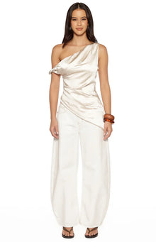 Front view of the cream satin asymmetric top showing the draped bodice and uneven hemline