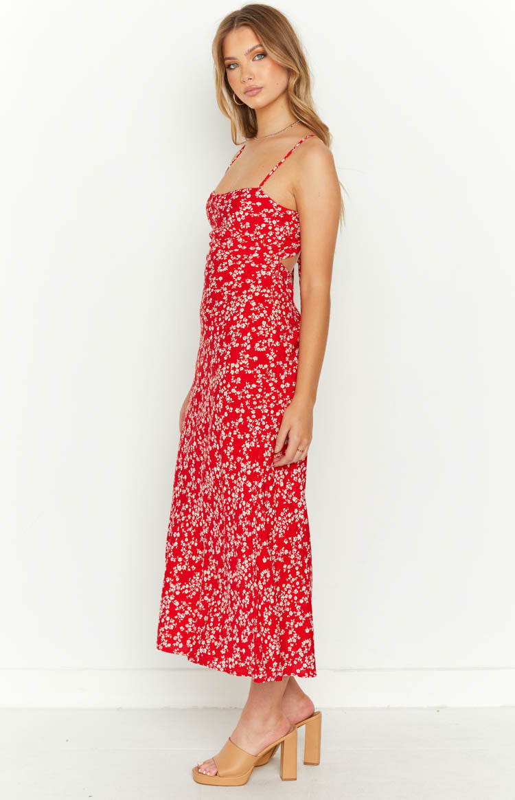 Side view of a red floral midi dress with a square neckline, thin straps, and side waist cutout