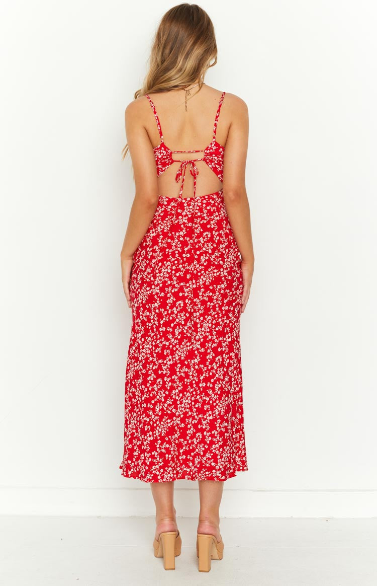 Rear view of a red floral midi dress with a tie-back bodice and waist cutouts