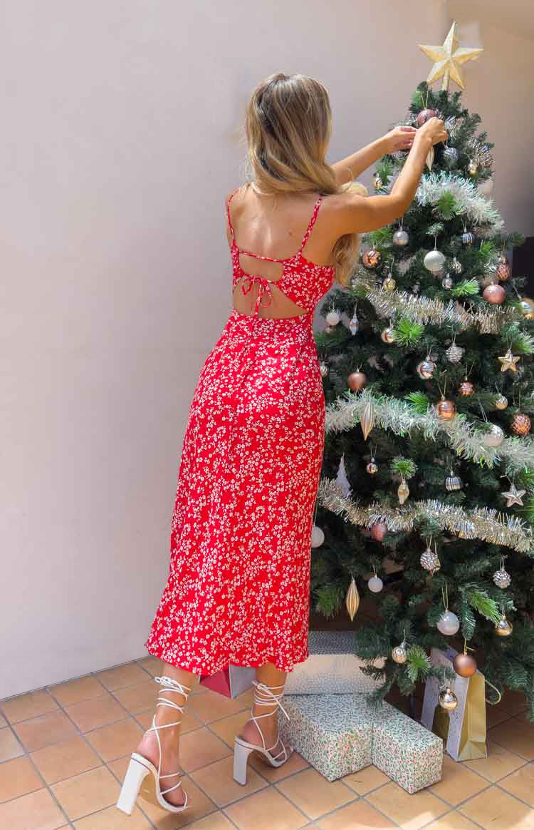 Rear view of a red floral midi dress with spaghetti straps and an open tie-back detail