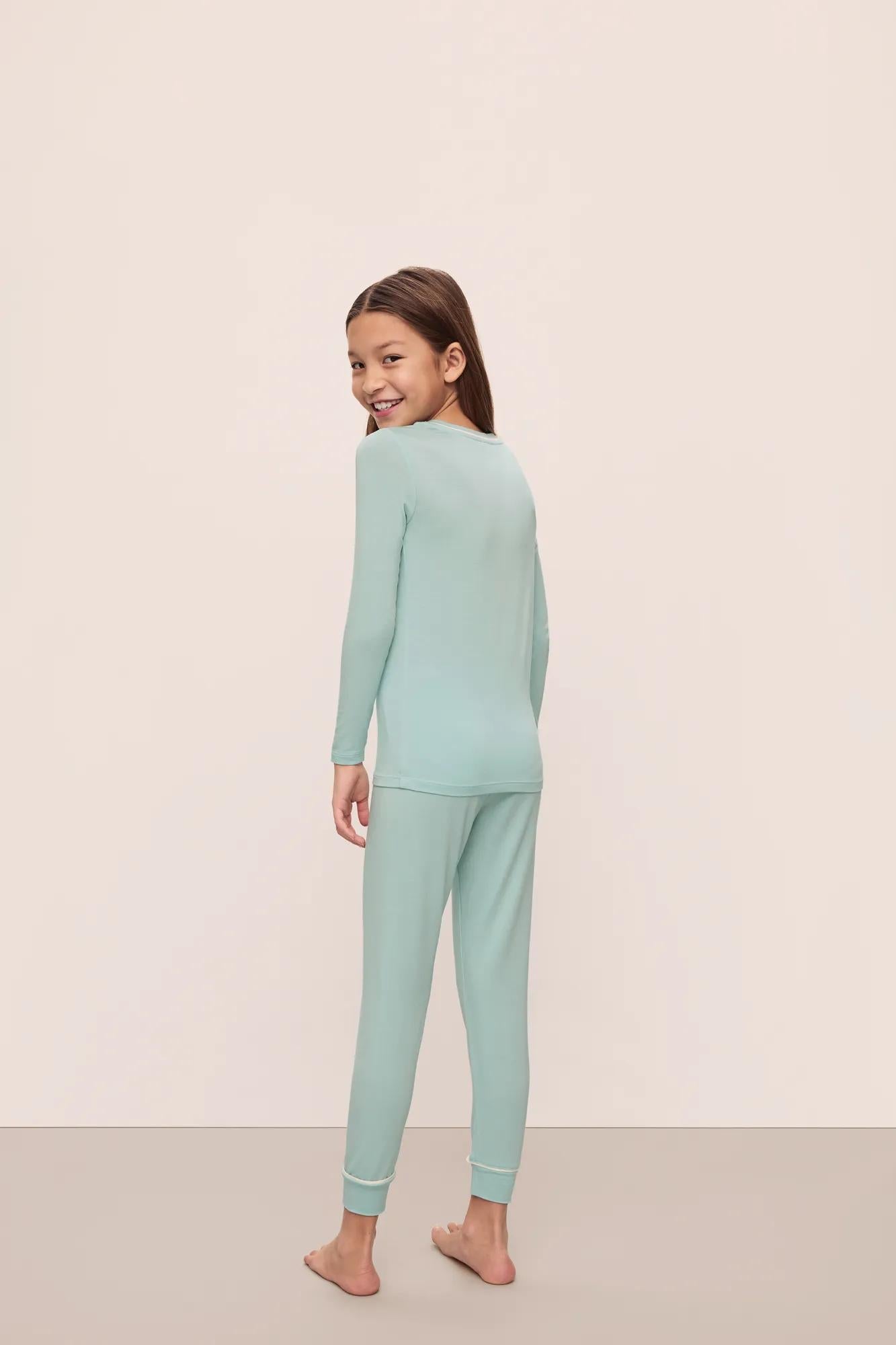 Model is wearing Kids Tencel Modal Unisex Long Pj Set in Canal Blue/Ivory