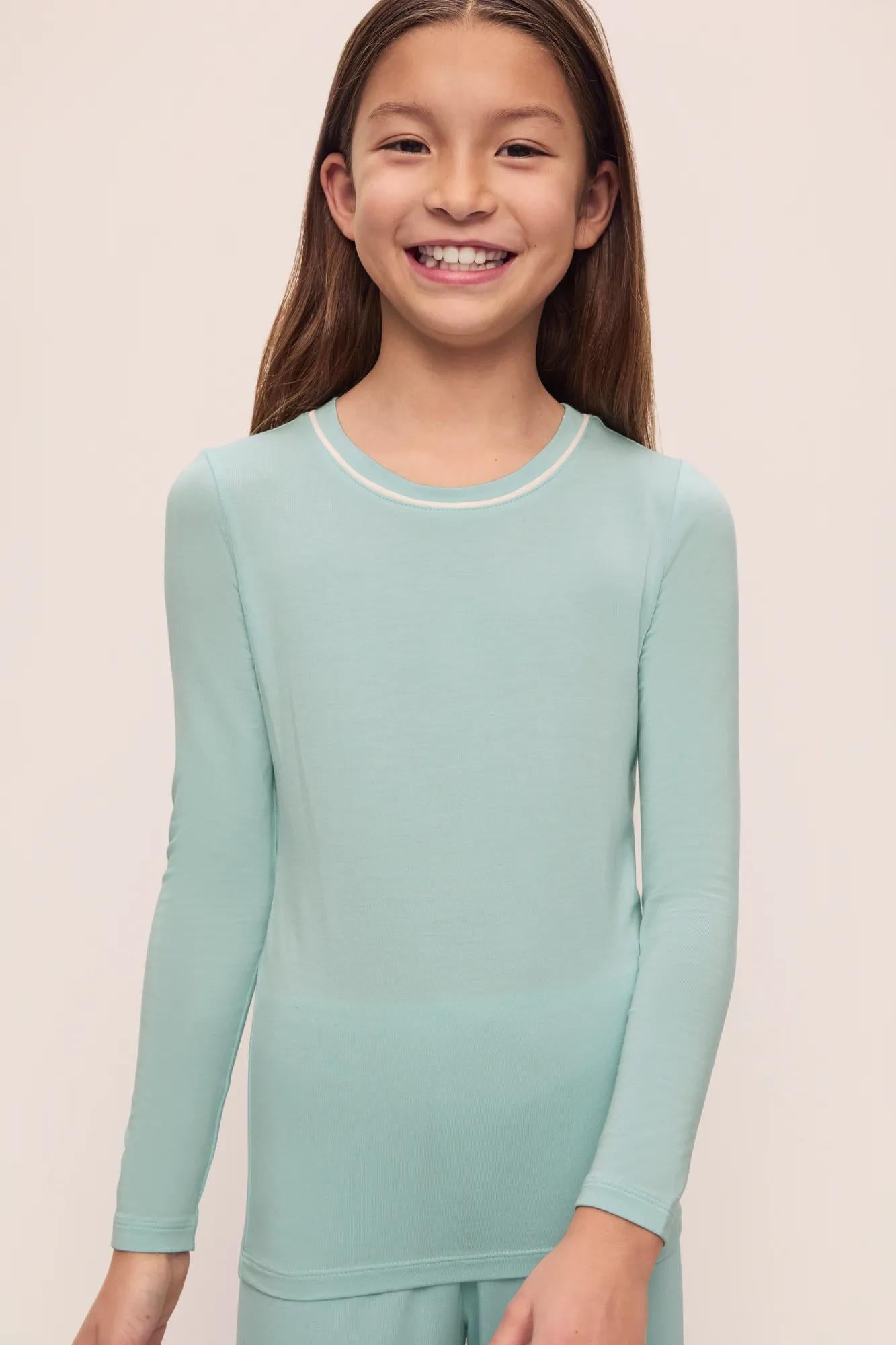 Model is wearing Kids Tencel Modal Unisex Long Pj Set in Canal Blue/Ivory