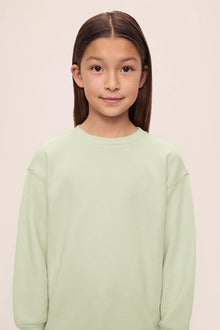 Model is wearing Kid's French Terry Sweatshirt and Jogger Set in  Matcha