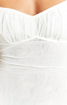 Close-up of the white sheer mesh fabric with ruched sweetheart neckline and fitted bodice