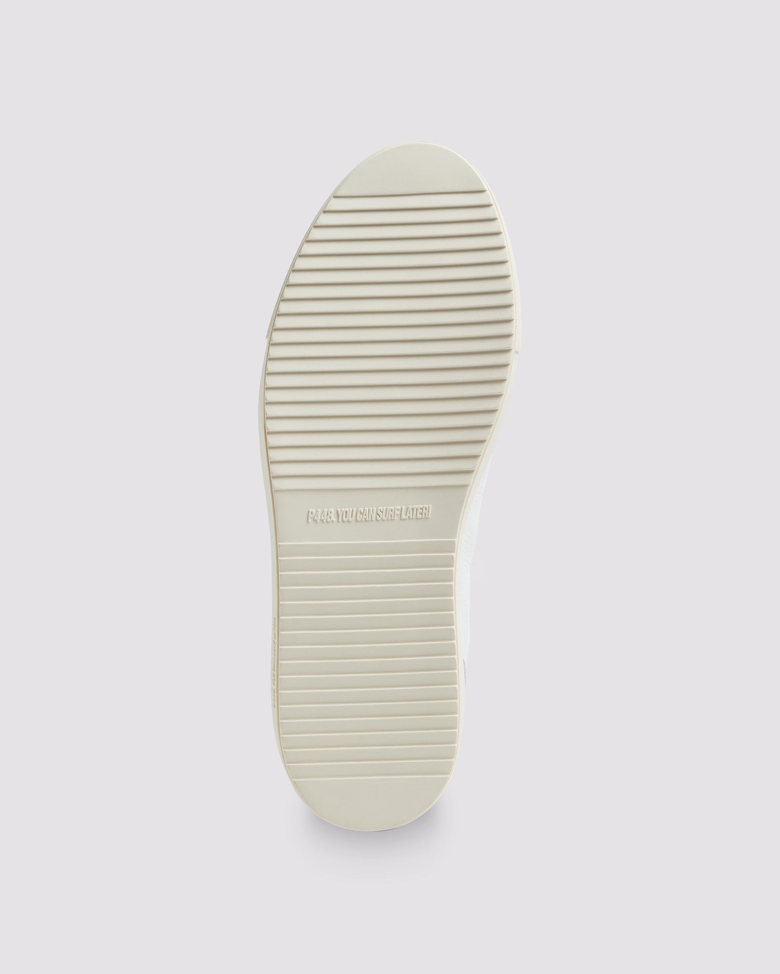 Bottom angle of white, grey and green sneakers