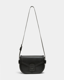 The Rudsak ALORA - 8324506 is a minimalist black crossbody bag crafted from premium leather, with a long adjustable strap, flap closure, and front clasp. Shown here against a plain white background.