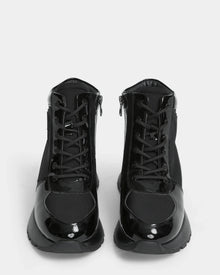 The Rudsak CHELSA - L224505 Black women’s sneaker boots feature glossy patent leather accents, lace-up fronts, and waterproof zipper sides, shown facing forward against a white background.