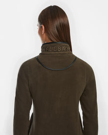 Seen from behind, a person with straight brown hair wears the Rudsak EDITH - 8524617 Army coat. The dark olive piece features RUDSAK embroidered on the high collar and vegan leather trim at the shoulders, set against a plain white background.