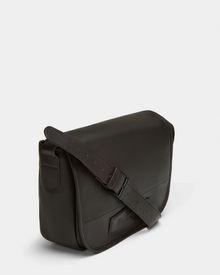 The Rudsak GRAYSON - 8324512 Espresso is a dark brown leather crossbody bag with a front flap, adjustable shoulder strap, and visible stitching, displayed against a plain light background.