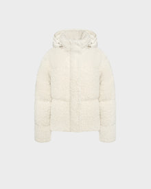 The Rudsak IKSA - 8124706 Iceland is a women’s white hooded teddy down puffer jacket with fleece texture, front zipper, and snap closure, shown against a plain light gray background.