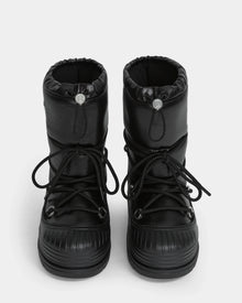 The Rudsak KIKA - L224506 Black women's winter boots feature a puffy design, chunky rubber soles, front laces, and drawstring closures, displayed from the front on a white background.