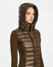 A woman in the MARRY - L121003 Light Olive puffer by Rudsak, featuring waterproof zippers.