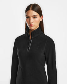 A woman with straight brown hair models the Rudsak ORCHID - 8524616 Black women’s half-zip pullover polar fleece sweater with vegan leather trims, standing against a plain white background and looking at the camera.