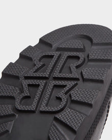 Close-up of the black sole on Rudsaks REAGAN - 6224501 boots, featuring a bold, raised pattern with interlocking BR letters and textured treads for top grip—ideal for men’s winter footwear.