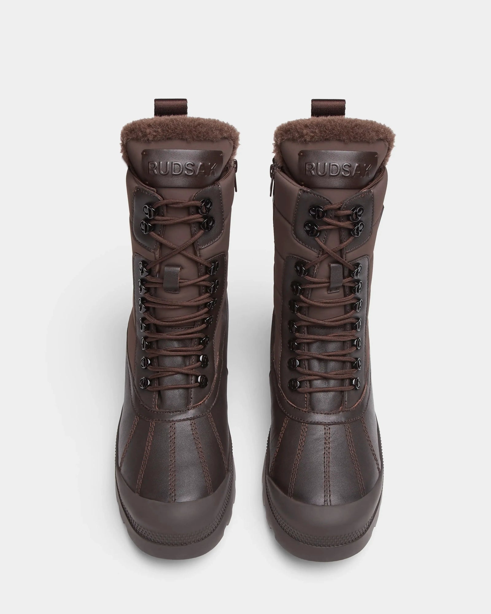 The REAGAN - 6224501 Espresso by Rudsak are dark brown high-top men’s winter boots with fur lining at the ankle and front laces, shown from above on a light background.