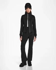 A woman in the Rudsak ROSALIE - 8124784 Black fitted ski jacket featuring RECCO rescue technology, dressed all in black.