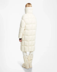 A person with short blonde hair, seen from behind, wears the Rudsak SASH - 8124536 Iceland long quilted winter coat, matching pants, and chunky off-white boots against a plain white background.