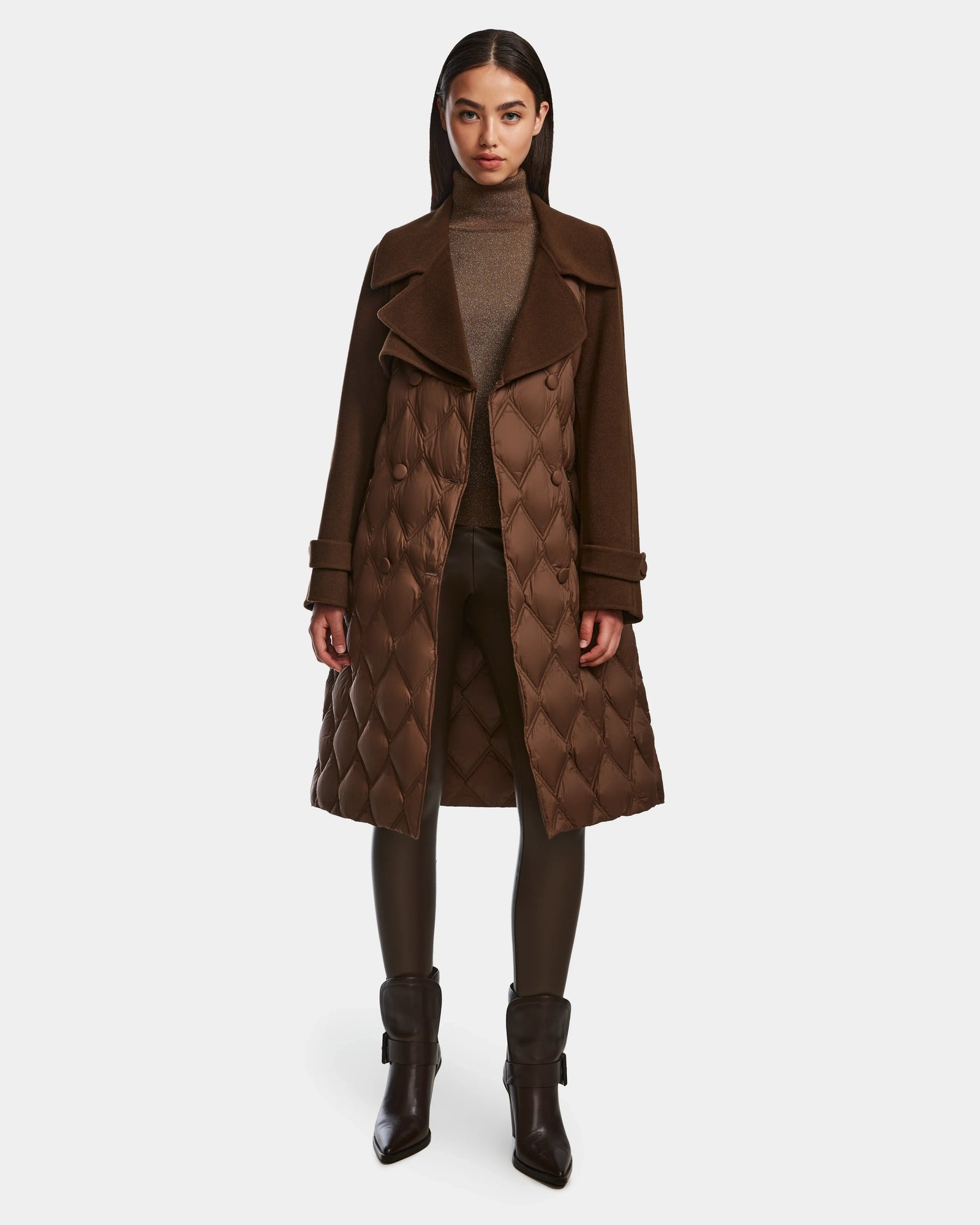 A woman faces forward against a white background, wearing the Rudsak ZOE - 8124711 Mocha quilted down wool trench over a taupe turtleneck, black leggings, and brown heeled ankle boots.