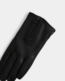 The Rudsak AUGUSTA - L425546 Black women’s glove, made from supple lamb leather with a sleek top zipper, stands out as a stylish cold-weather essential against a plain light gray background.