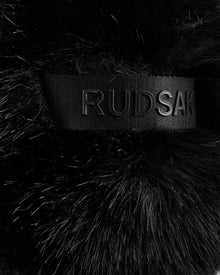 A close-up of the black faux fur and embossed Rudsak band on the DEMI - L425539 Black highlights the luxe detail of this women’s aviator hat—a stylish and cozy winter choice.
