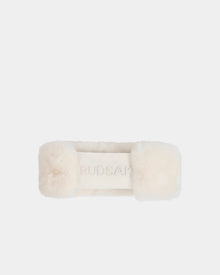 The SANDIE - L425552 Iceland by Rudsak is a cream-colored rectangular faux fur women’s headband with RUDSAK embossed in the center, shown on a plain white background—an elegant winter accessory.